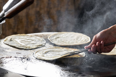 Delicious flatbread cooking on hot surface.の写真素材