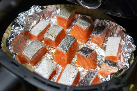 Delicious salmon fillets cooking in foil. Healthy and easy meals from air fryerの写真素材