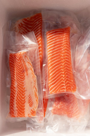 Fresh salmon fillets in vacuum packaging.の写真素材