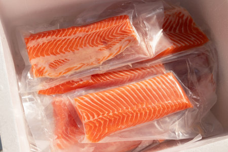 Fresh salmon fillets in vacuum-sealed packagingの写真素材