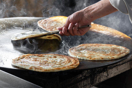 Delicious flatbread cooking on hot surface.