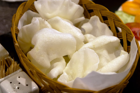 Crispy white crackers in a bamboo basket.の写真素材