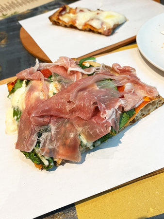 Parma ham pizza with cheese and rocket salad.の写真素材
