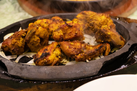 Delicious sizzling chicken on a hot plate.の写真素材