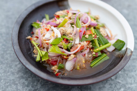 A vibrant plate of fresh salad, featuring colorful ingredients and herbs.の写真素材