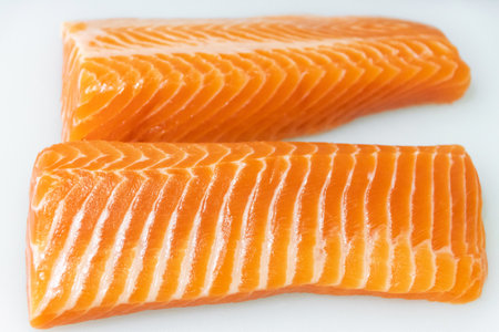 Fresh salmon fillets with vibrant orange color, perfect for cooking and healthy meals.の写真素材