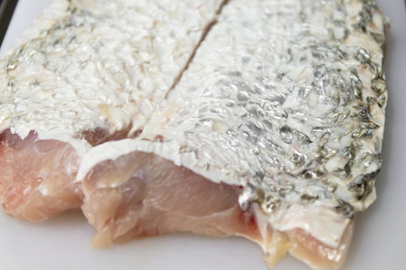Fresh fish fillet with shiny scales, ideal for culinary photography and seafood dishes.の写真素材