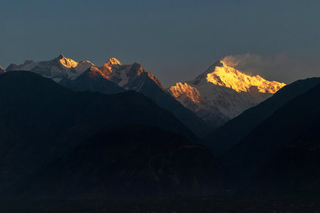 Majestic mountain peak bathed in sunrise glow. Rakaposhi is a mountain within the Karakoram range in Gilgit-Baltistan in Pakistan.の写真素材