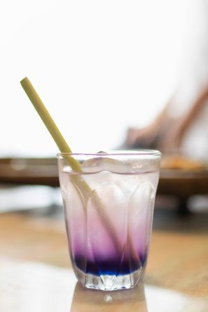 Butterfly pea with lemon juice on ice in transparent glass with lemongrass stick.の写真素材