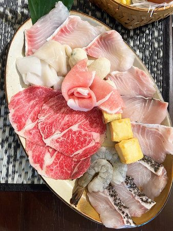 An array of fresh fish, meat and seafood with vegetables.の写真素材