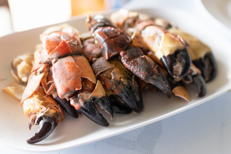 Steamed stone crab claws served with a spicy seafood dipping sauce are popular dishes in local street food in Thailand.の写真素材