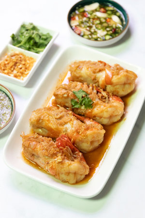 Garlic shrimp stir-fry with Thai spicy seafood dipping sauce on white plate; easy and delicious menu.の写真素材