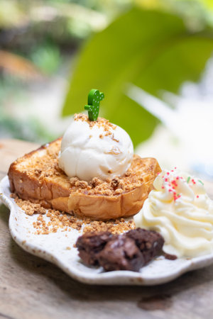 Delicious dessert featuring toasted bread topped with cream, nuts, and chocolate. Perfect for indulgent occasions and food photography.の写真素材