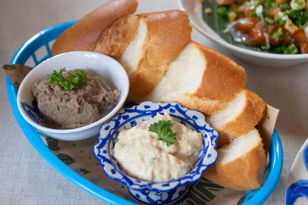 Delicious spread served with fresh bread, perfect for sharing and enjoying a flavorful meal at any gathering.の写真素材