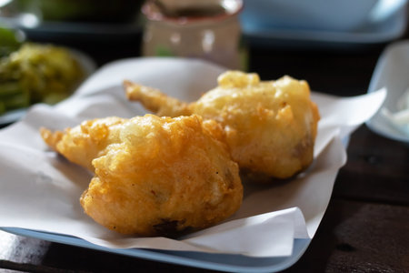 Deliciously crispy golden fried snacks served on a white plate, perfect for appetizers or indulgent bites.の写真素材