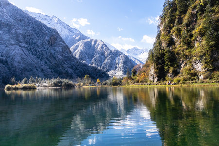 A Bipenggou in autumn winter is a "fairytale" winter landscape with snow covered mountain lake reflection serene autumn valley.の写真素材