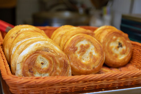 A Guo Kui, Crispy stuffed flatbread is truly scrumptious with flaky and crispy layers on the outside and a flavorful and delicious filling on the inside. Chengdu street food, China.の写真素材
