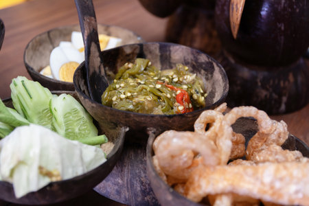 A Nam Prik Noom Recipe (Northern Thai Green Chili Dip); is a common meal in northern Thailand. Always served with vegetable, sticky rice and crispy pork skin.の写真素材