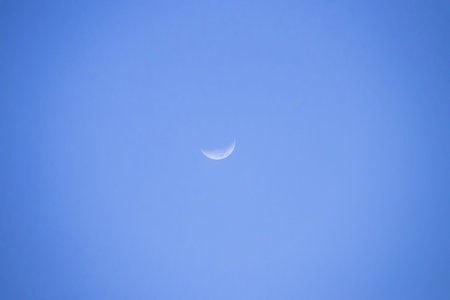 A crescent moon sky blue twilight celestial minimalの写真素材