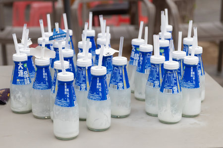 A Dalian, China-June 6, 2026: Fresh famous cultured drinking yogurt from Dalian, China. Packaged in a classic glass bottle, trendy photo prop for tourists checking in around the city.