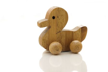 wooden toy duck isolated on whiteの写真素材