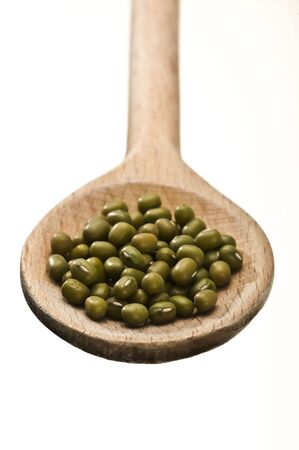 wooden spoon with rice isolated on white backgroundの写真素材