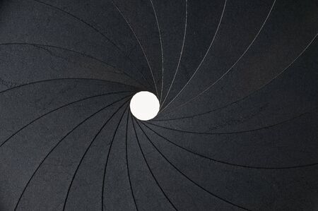 metal aperture with small hole as backgroundの写真素材