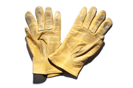 pair yellow leather gloves isolated on white backgroundの写真素材