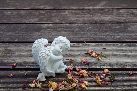 white angel sculture on the wood floorの写真素材