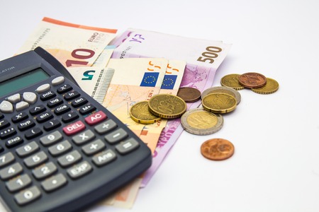 Euro Money banknote and coins with calculator isolated white backgroundの写真素材