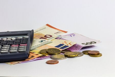 Euro Money banknote and coins with calculator isolated white backgroundの写真素材