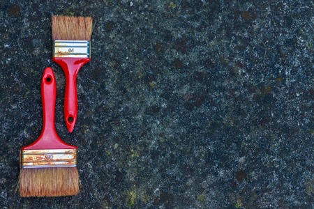 Old dirty brushes on stone backgroundの写真素材