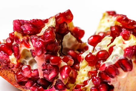 Pomegranate seeds close up on white background.の写真素材