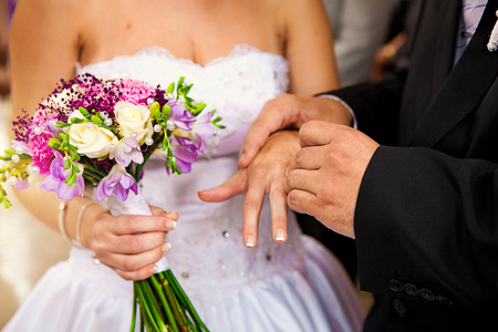 Beautiful colorful wedding bouquet with bride and groomの写真素材