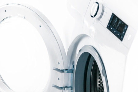 Washing machine with an open door detail on white background