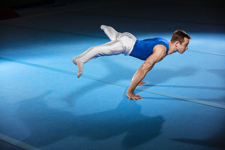 portrait of young man gymnasts competing in the stadiumの写真素材