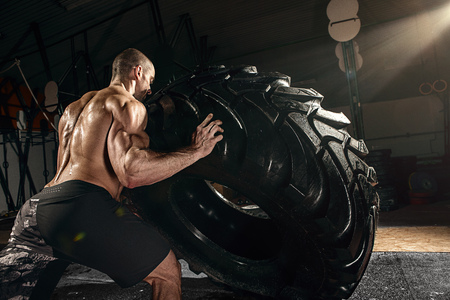 muscle cross strongman training - man flipping big tireの写真素材