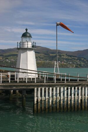 Old white wooden lighthouse in Lyttleton harborの写真素材