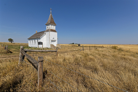 A small white church lost in the plains of North Dakotaの写真素材