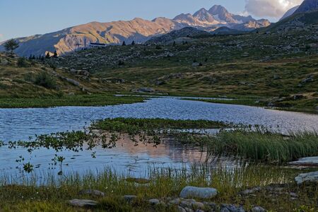 Reflections on a mountain lake of French Alps at duskの写真素材
