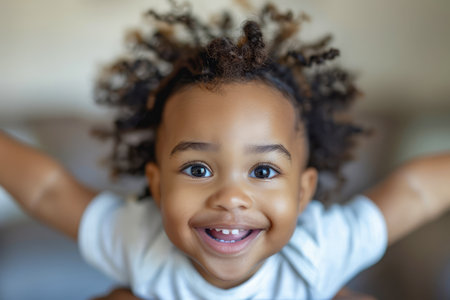 Adorable Toddler with Curly Hair Smiling Cheerfully, Arms Stretched Out for a Hug, Joyful Child Expression Captured in Natural Light AI Generativeの素材