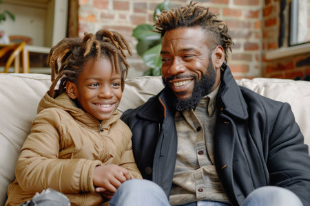 Smiling African American Father and Daughter Bonding on Sofa in a Cozy Home Environment AI Generativeの素材