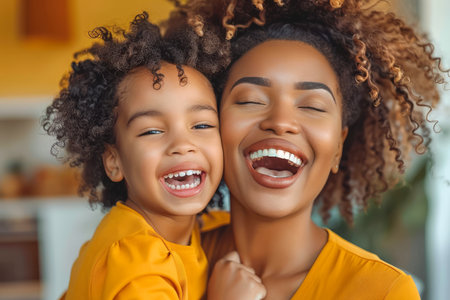 Joyful African American Mother and Child Hugging and Laughing Together in a Warm Home Setting AI Generativeの素材