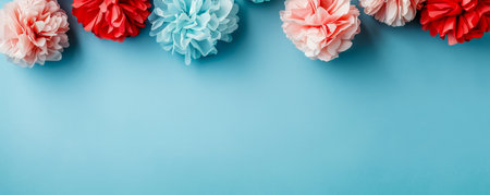 Vibrant Paper Pom poms Arrangement on a Pastel Blue Background Top View Party Decorations Concept AI Generativeの素材