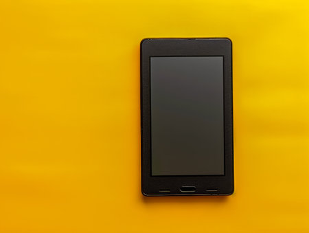 Black E reader on Vibrant Yellow Background Minimalist Design Concept for Modern Technology AI Generativeの素材