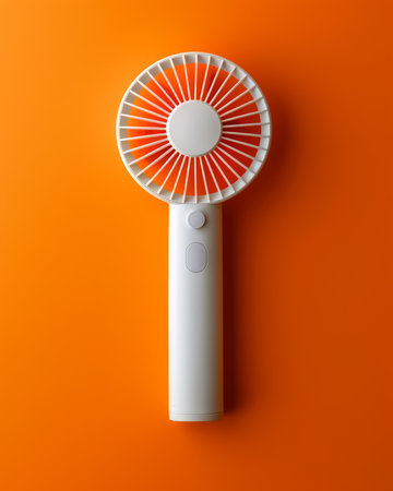 Portable Handheld Personal Fan, Mini USB Rechargeable Battery Operated Cooling Fan for Home, Office, Travel, Outdoor Activities, and Sports, Compact and Lightweight Design in White and Orange AI Generativeの素材