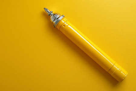 Bright Yellow Fountain Pen on Vibrant Yellow Background High Contrast Artistic Stationery Photography for Creative and Professional Writing Projects AI Generativeの素材