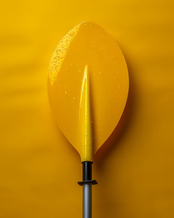 Bright Yellow Kayak Paddle on Solid Yellow Background Minimalist Adventure Gear Image for Outdoor Enthusiasts and Water Sports Lovers AI Generativeの素材
