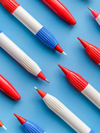 Colorful Assortment of Red White and Blue Pens on Blue Background Perfect Office School and Art Supplies AI Generativeの素材