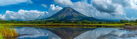 Immerse yourself in the breathtaking panorama of a majestic dormant volcano, its towering presence mirrored in the serene waters of a reflective lake Beneath a vibrant blue sky, lush greenery carpets the volcanic slopes, while billowing white clouds dance above, their ethereal beauty reflected in the glassy surface of the lake Experience the tranquility and awe-inspiring grandeur of this volcanic masterpiece AI Generativeの素材